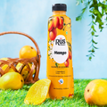 organic mango juice bottle out side in the nature under the mango tree surounded by mangos